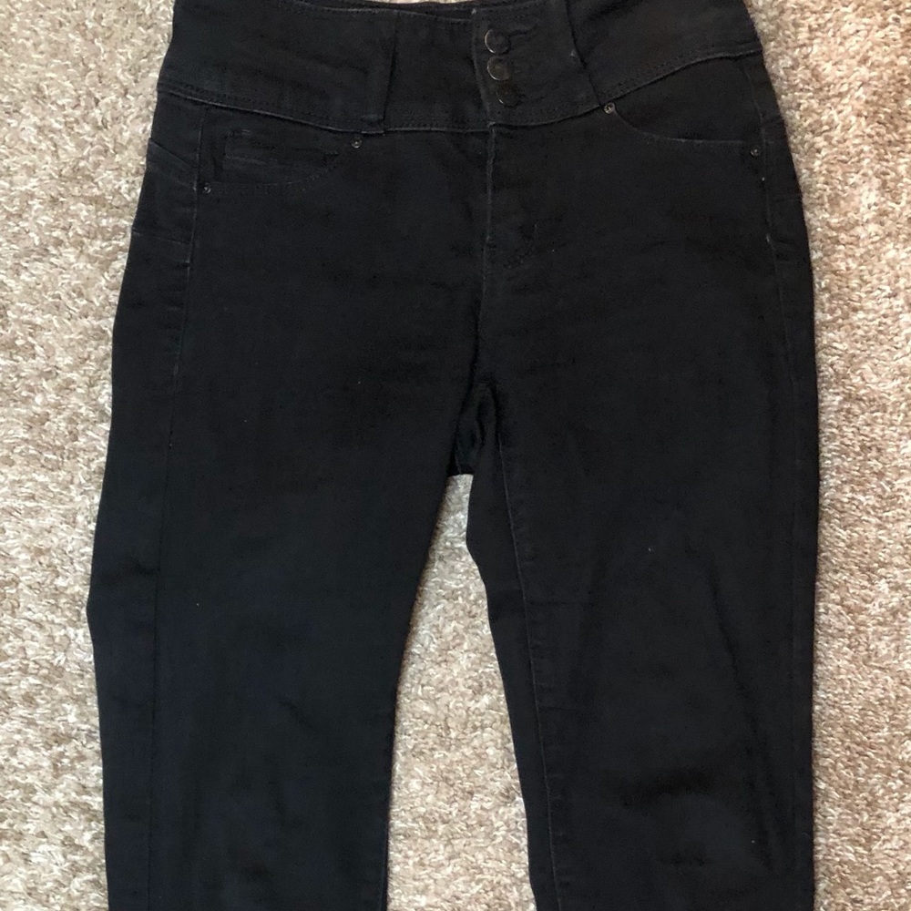 This is a black jean cropped at the ankle.